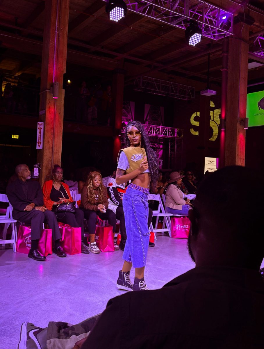 A runway model poses at the Surround Sound of Fashion show at Cine City Studios on Saturday, Oct. 12, 2024. The event included live music and showcased the work of local designers.