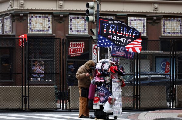 A vendor organizes his cart of merchandise before taking off to find another location on Monday, Jan. 20, 2025, in Washington, D.C. There were hundreds of vendors present for Inauguration Day, crowding the streets and sidewalks.