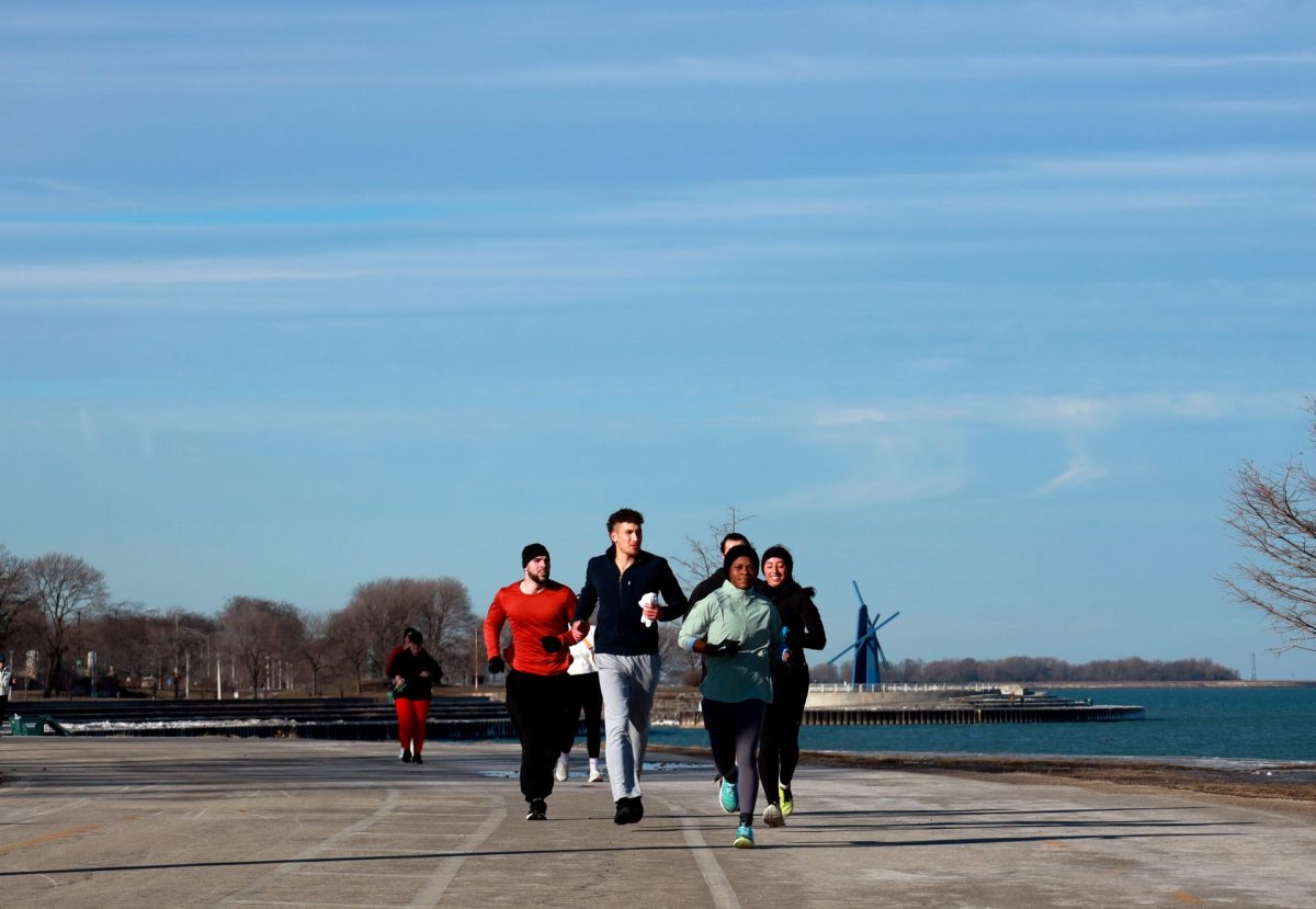 Rheema Ayyash and club members travel along Lake Shore Drive for an afternoon run on Jan. 17, 2025. Ayyash is the president and founder of Demons on the Run, a student organization that runs together multiple times each week.