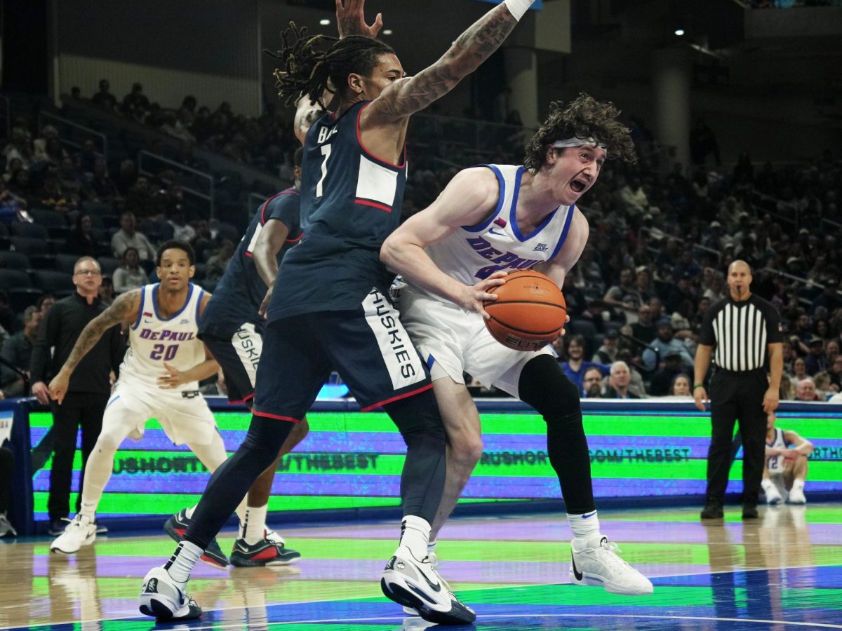 DePaul guard, Conor Enright, holds and defends the ball against UConn on Wednesday, Jan. 1, 2025, at Wintrust Arena. Enright scored 18 points in the 81-68 loss.