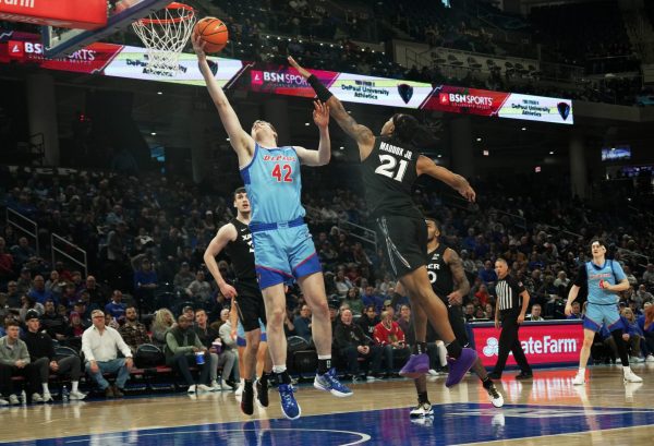 David Skogman goes for a layup while Xavier's Dante Maddox Jr. tries to block the shot on Saturday, Jan. 11, 2025, in Chicago. Skogman appeared and started in 17 games before suffering a season-ending injury last season at Davidson. 