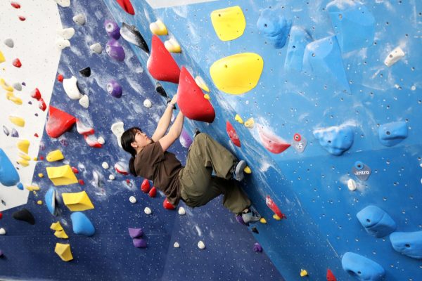 Joy Kwok boulders up the wall on Friday, Jan. 17, 2025. Movement Lincoln Park has more than 43,000 square feet of climbing and fitness facilities.