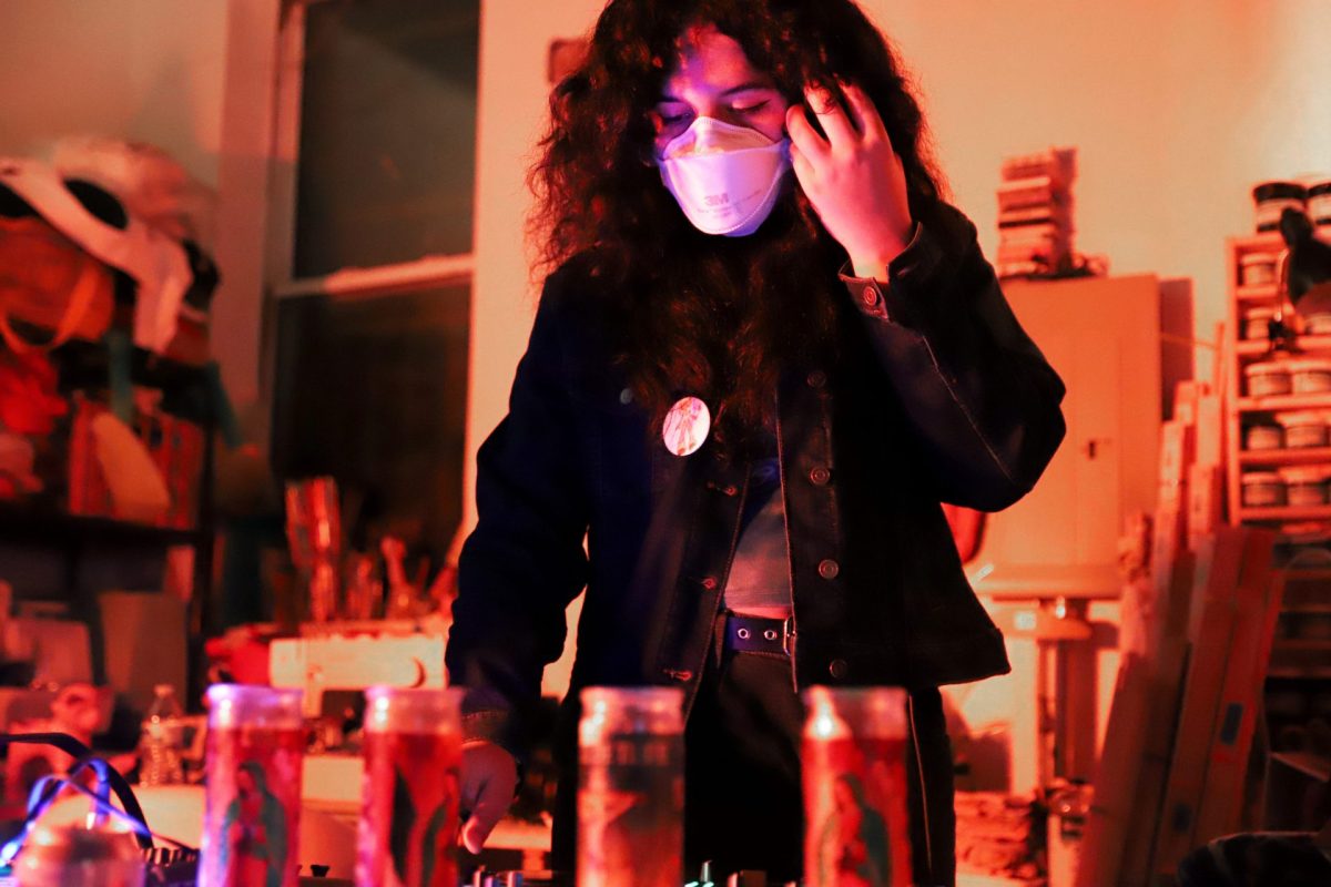 Teala Torres, also known as DJ Tee Vera, adjusts her headphones as she mixes for Humboldt Park’s Happy Gallery on Oct. 26, 2024. Happy Gallery hosted CityPill, a queer underground music showcase that featured various performers of the scene.