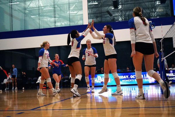 DePaul volleyball players cheer on the court on Friday, Sept. 21, 2024, at McGrath-Phillips Arena. DePaul hosted the Chicago Cup from Sept. 19-21.