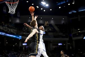 NJ Benson throws up a shot while Ben Gold attempts to block during the first half of the game on Tuesday, Jan. 14, 2025, at Wintrust Arena. DePaul was able to go on a 15-3 run over about five and a half minutes leading to a three-point game.