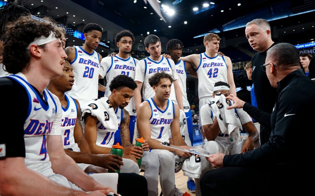 DePaul men's basketball players listen as their coaches speak during a time out on Tuesday, Jan. 14, 2025, during the second half at Wintrust Arena. Marquette and DePaul were trading the lead throughout the second half.