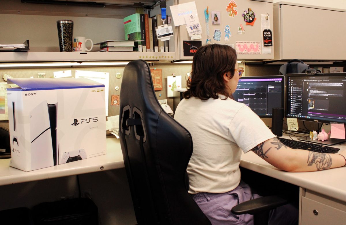 Liz Becker, a library attendant, logs a new PS5 into the system on Wednesday, Jan. 15, 2025, in Lincoln Park. The DePaul library updated the selection of digital media and resources available to students. 