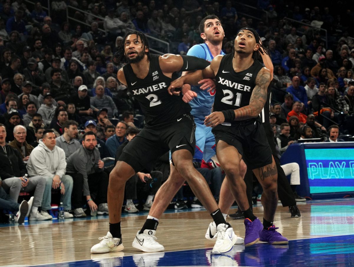 Xavier's Jerome Huner and Dante Maddox Jr. block Troy D'Amico on Saturday, Jan. 11, 2024, at Wintrust Arena. D'Amico comes from Southern Illinois. 