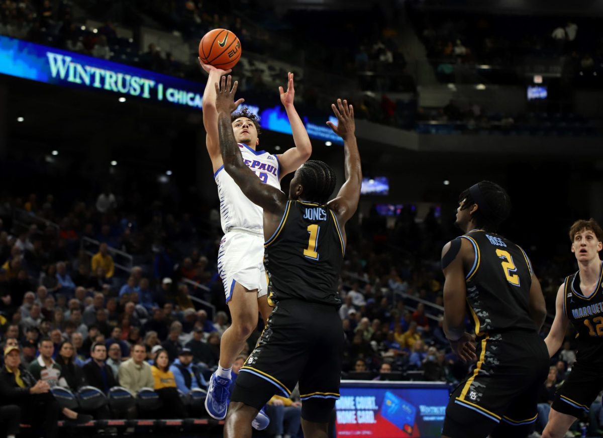 Jacob Meyer jumps for a shot while Marquette's Kam Jones guards on Tuesday, Jan. 14, 2025, during the first half. Meyer ranked fifth nationwide in points per game among true freshman during his time at Coastal Carolina. 