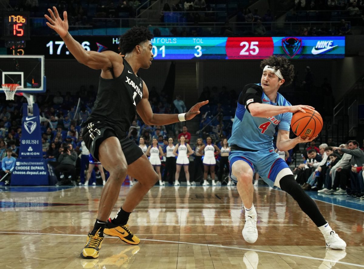 Conor Enright looks to pass the ball while Xavier's Marcus Foster guards on Saturday, Jan. 11, 2025, at Wintrust Arena. Enright scored five points during the game.