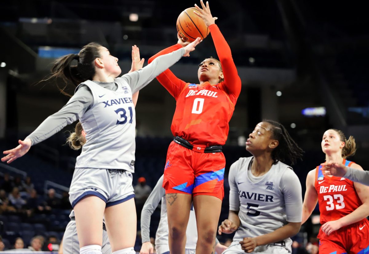 Taylor Johnson-Matthews jumps for a shot while Irune Orio goes to block on Wednesday, Jan. 22, 2025, at Wintrust Arena. Johnson-Matthews scored 12 points. 