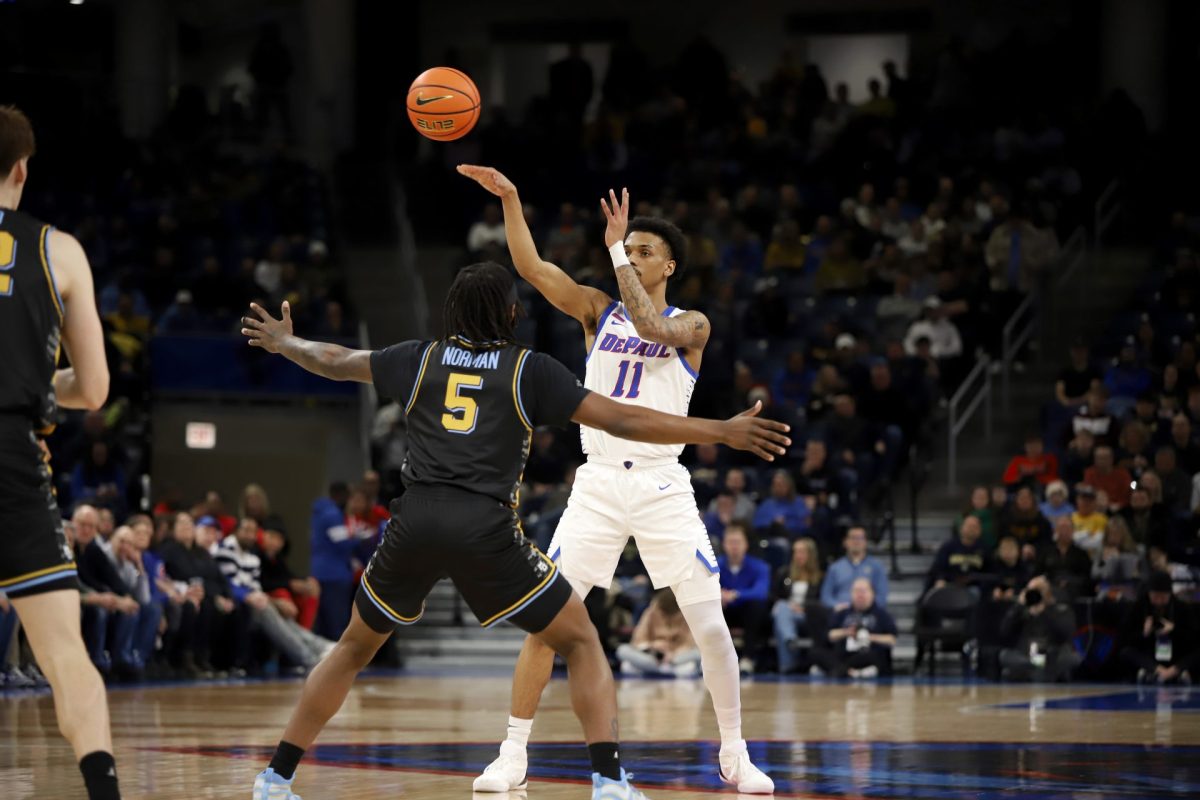 CJ Gunn passes the ball while Tre Norman guards on Tuesday, Jan. 14, 2025, at Wintrust Arena. Gunn started the game. 