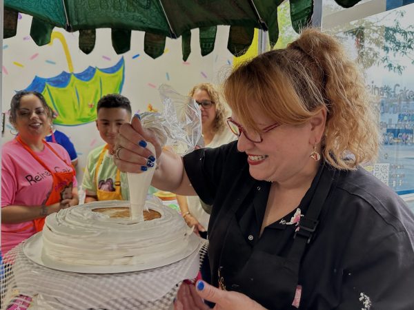 Reina Marcelle, owner of Reina's Cakes, frosts a cake during a cake decorating class at her shop in Chicago's Humboldt Park neighborhood on September. 28, 2024. Marcelle teaches cake decorating classes to kids and adults in addition to selling cakes.