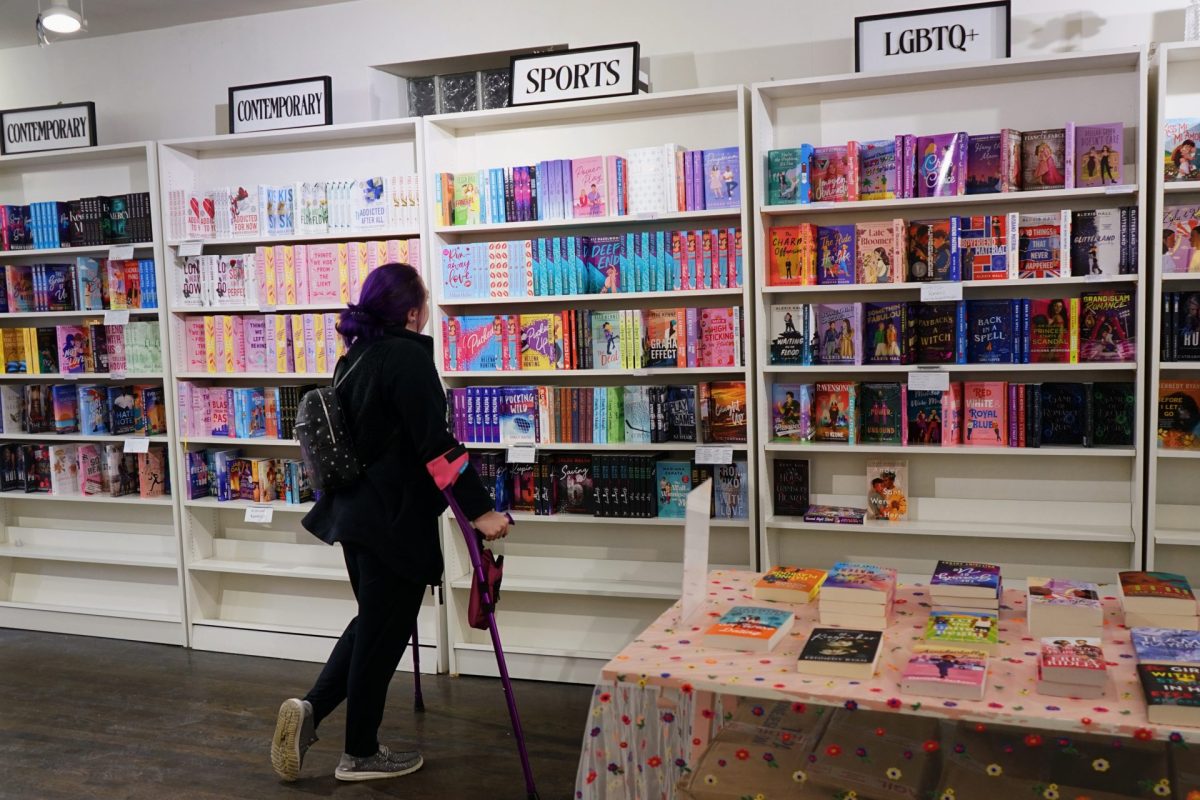 A customer browses the shelves at The Last Chapter Book Shop on February 6, 2025. The Roscoe Village store specializes in romance novels of all sub-genres.