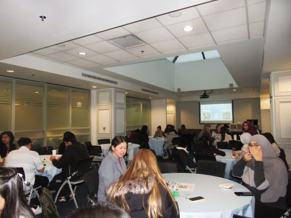 Event attendees sit and talk with one another at the EmpoHer event on Monday, Feb. 3, 2025. DePaul Women in Business is a student-run organization which connects students with professionals.