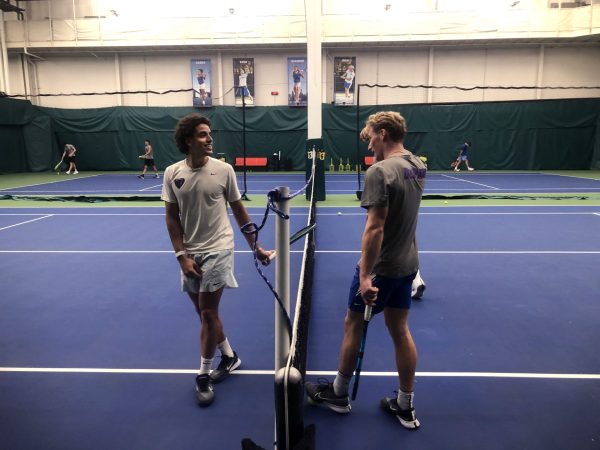 Matteo Iaquinto, left, and Jona Gitschel talk at the net during practice at Lake Shore Sports and Fitness on Tuesday, Feb. 4, 2025. Iaquanto is proud to find himself in a leadership role, saying that it pushes him to “behave a certain way” and “show the young guys how everything is done.”