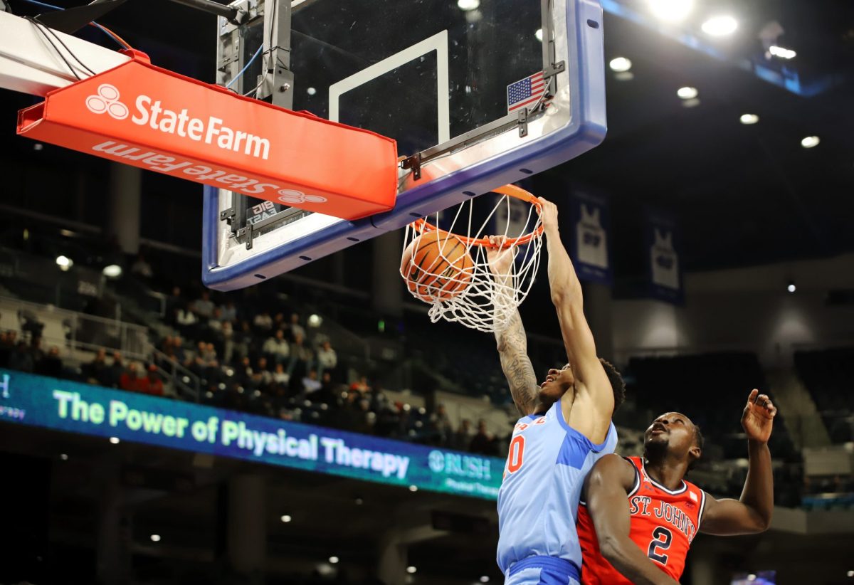 JJ Traynor makes a dunk while Sadiku Ibine Ayo falls behind on Wednesday, Feb. 19, 2025, at Wintrust Arena. Traynor started the game. 