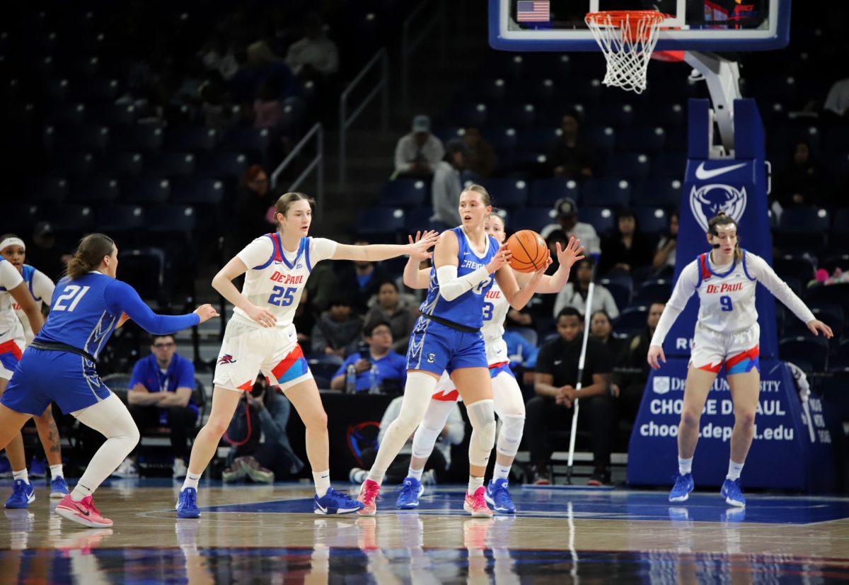 Morgan Maly looks for a pass while Kate Clarke tries to block on Sunday, Feb. 23, 2025, at Wintrust Arena. Before the game against Creighton, DePaul has a 7-7 home record.