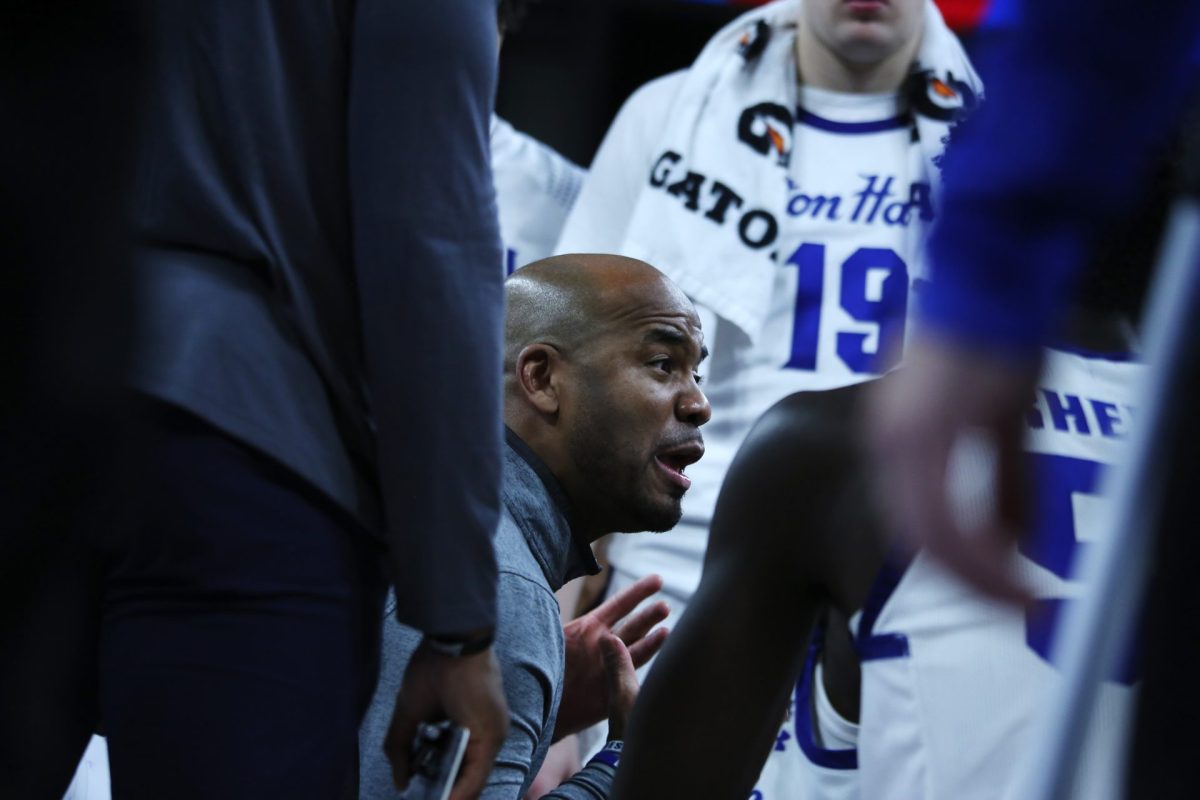 Seton Hall head coach Shaheen Holloway talks with players during a first half timeout at Wintrust Arena on Sunday, Feb. 2, 2025. The game heated up at the end of the second half after a set of clock errors and fouls.