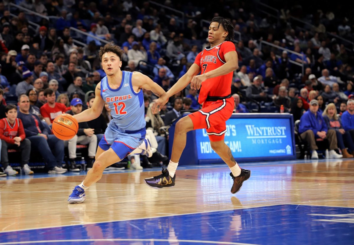 Jacob Meyer looks to the basket while dribbling down the court while Simeon Wilcher guards on Wednesday, Feb. 19, 2025, at Wintrust Arena. Meyer played the last several minutes in the first half without his shoe.