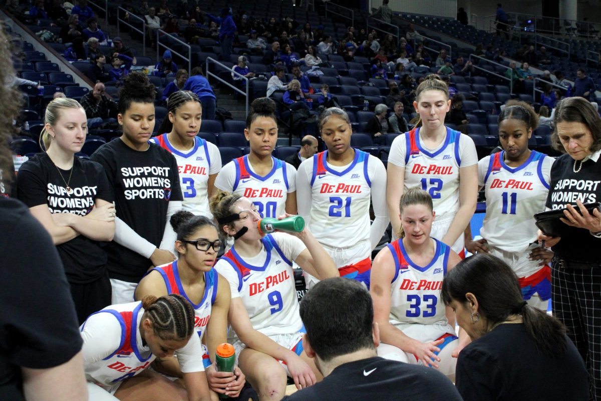 DePauls women's basketball team gathers during a second half timeout at Wintrust Arena on Friday, Feb. 1, 2025. Some players wore "Support Women's Sports" shirts.