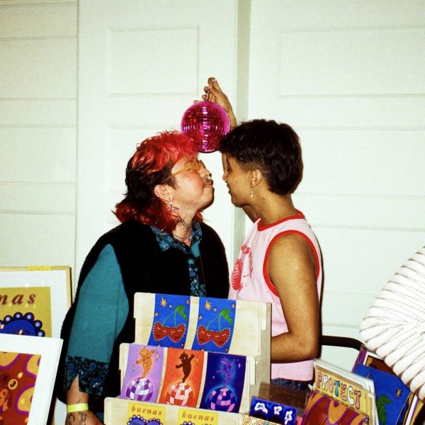 Tichike Tumalan and his partner Jai Perez prepare for a kiss at Club Qpid on Sunday, Feb. 11, 2024. The two have been together for three years, with Tumalan being the first transgender person Perez had ever met. (Photo provided by Els Folger)