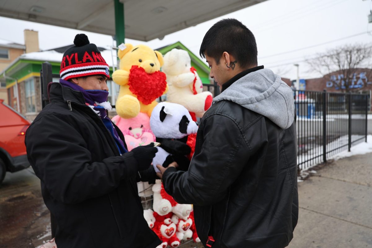 Cástulo García sells a panda bear to a customer on Feb. 15 in the Brighton Park neighborhood. He said he is motivated to sell flowers because his parents' advice rings in his mind. 