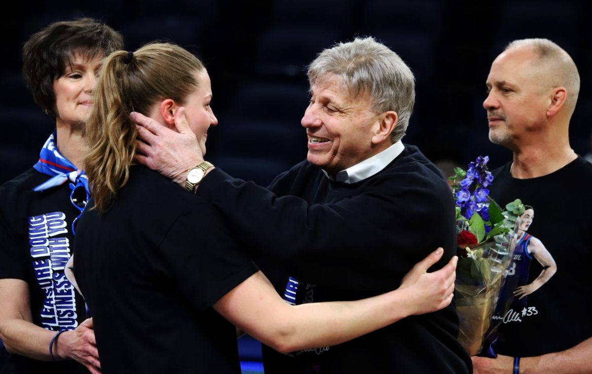 Doug Bruno and Jorie Allen hug each other at the beginning of the game on Sunday, March 2, 2025, at Wintrust Arena. Allen, a graduate student, was commemorated and will be playing her last regular season game as a Blue Demon.