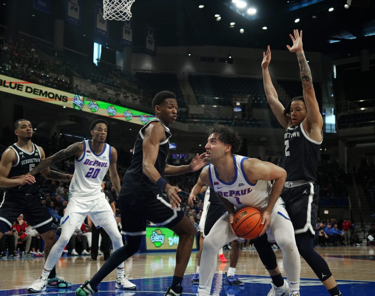 Isaiah Rivera holds the ball close as Georgetown crowds him on Saturday, March 8, 2025, at Wintrust Arena. Rivera led DePaul in points throughout the first half. 