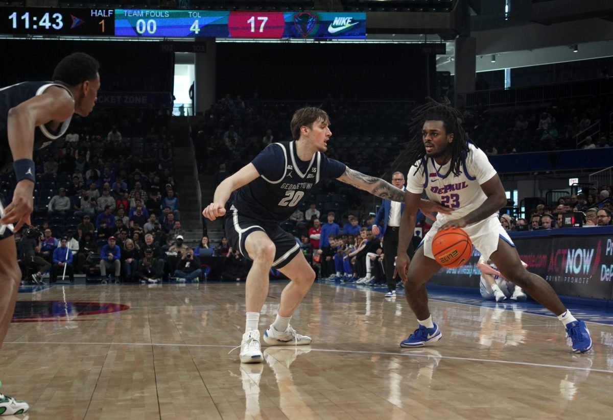 David Thomas looks to dribble past Drew Fielder on Saturday, March 8, 2025, at Wintrust Arena. The Blue Demons maintained their offensive strength throughout the first half.