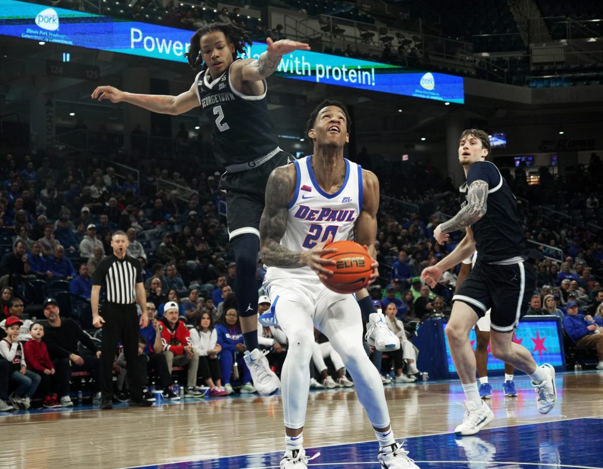 JJ Traynor looks to shoot the ball while Malik Mack comes in from behind on Saturday, March 8, 2025, at Wintrust Arena. Traynor started the game. 