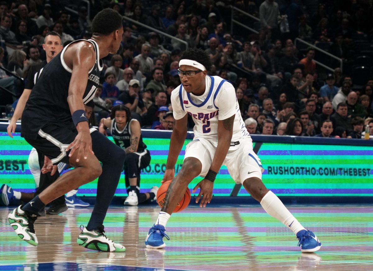 Layden Blocker dribbles while Georgetown blocks during the second half of the game on Saturday, March 8, 2025, at Wintrust Arena. Blocker's dunk sealed the victory for the Blue Demons. 