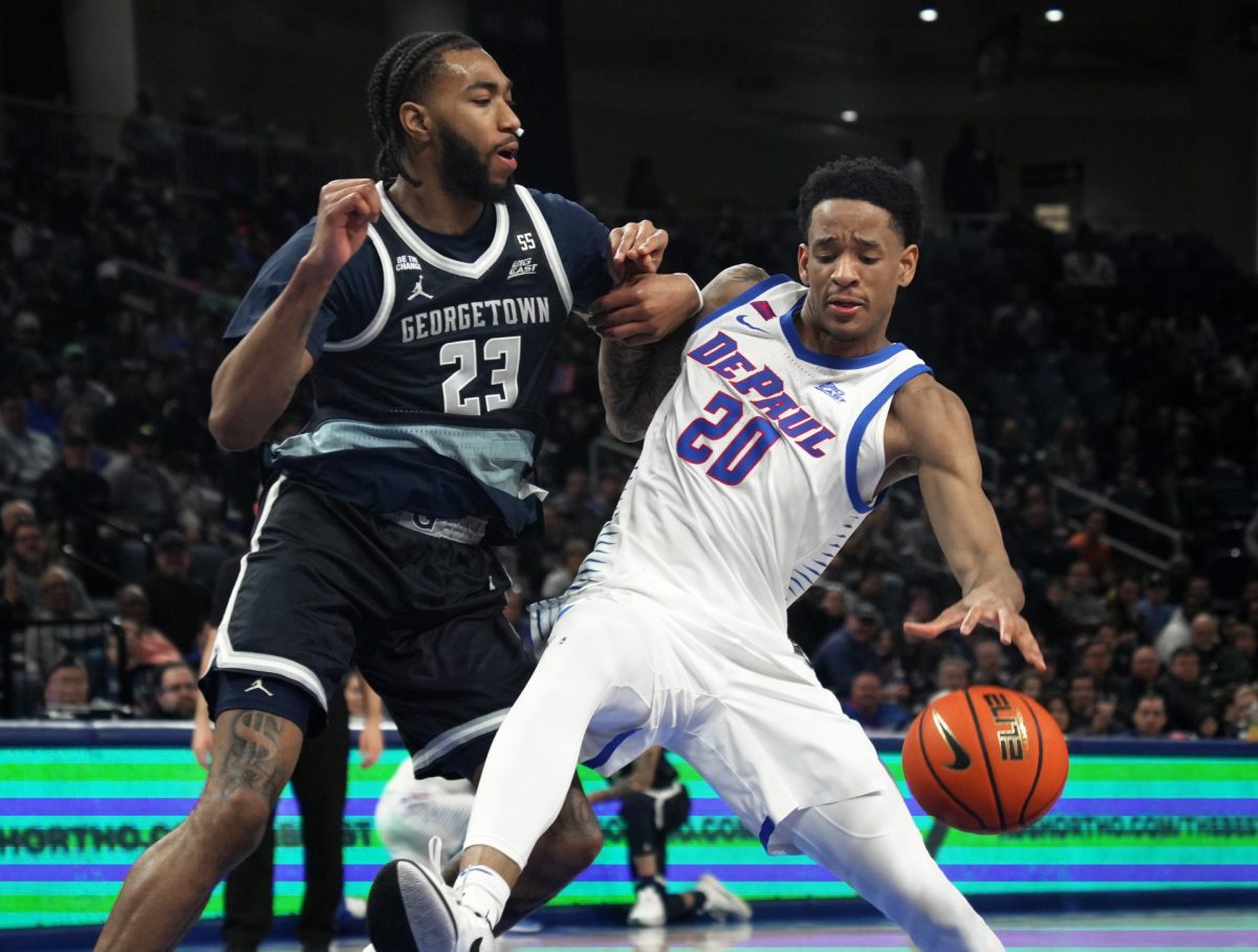 JJ Traynor tried to keep control of the ball while Jordan Burks guards on Saturday, March 8, 2025, at Wintrust Arena. Traynor scored 12 points during the game. 