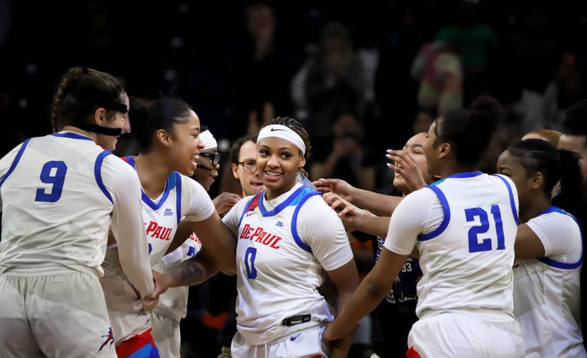 Taylor Johnson-Matthews celebrates with her team after they won against St. Johns on Sunday, March 2, 2025, at Wintrust Arena. Johnson-Matthews scored two free throws that earned DePaul the win. 