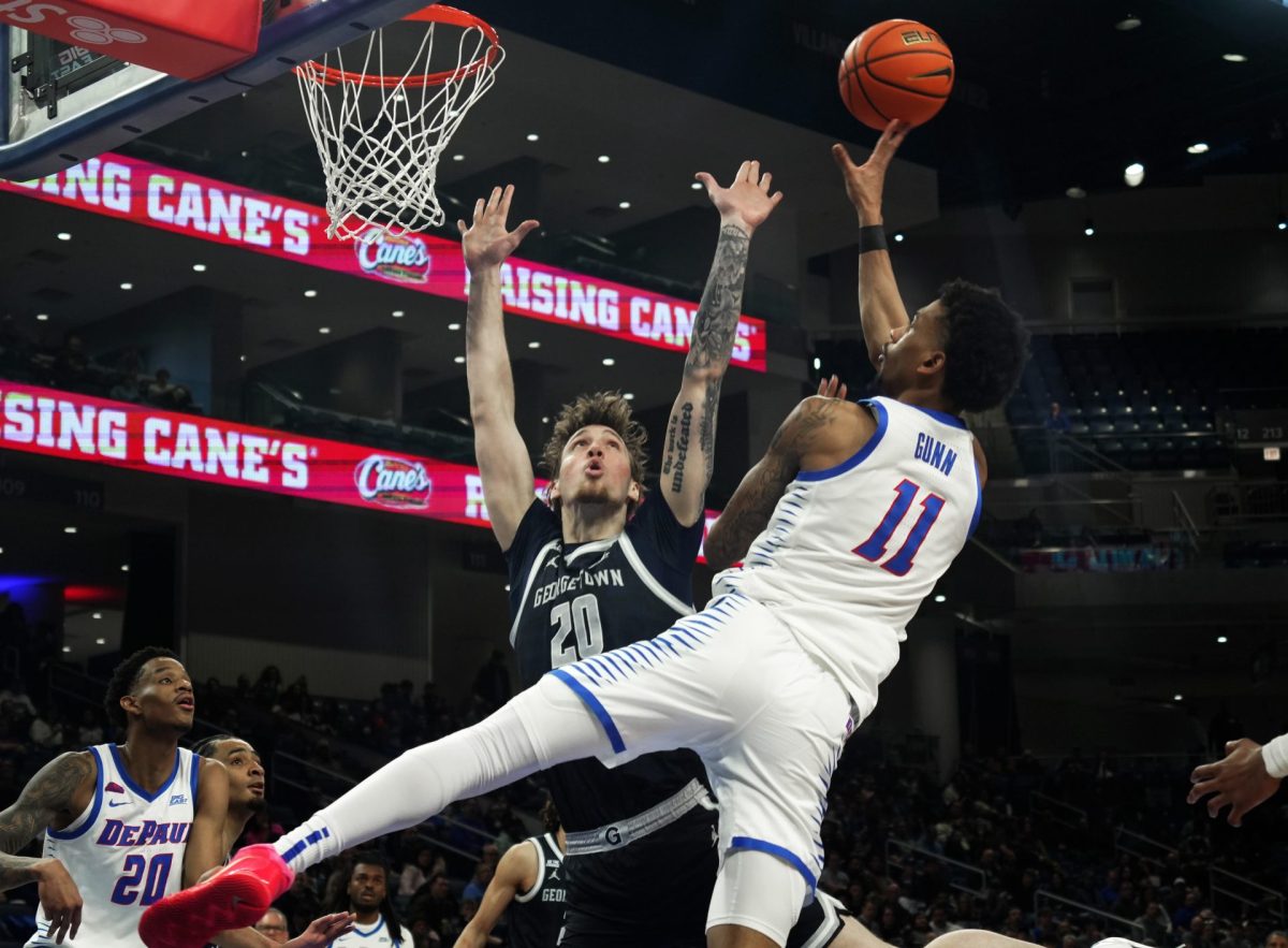 CJ Gunn goes up for a shot while Drew Fielder jumps to block the shot on Saturday, March 8, 2025, at Wintrust Arena. Gunn scored 17 points. 