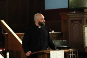 Seth Botts glances around the room as he preaches to the congregation of United Church of Rogers Park on Sunday, March 2, 2025. "When we encounter the light of God," Botts said. "We do not leave the same."