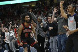 Chicago Bulls' Coby White (0) celebrates after making a three-point basket during the final seconds of an NBA basketball game against the Los Angeles Lakers Thursday, March 27, 2025, in Chicago.