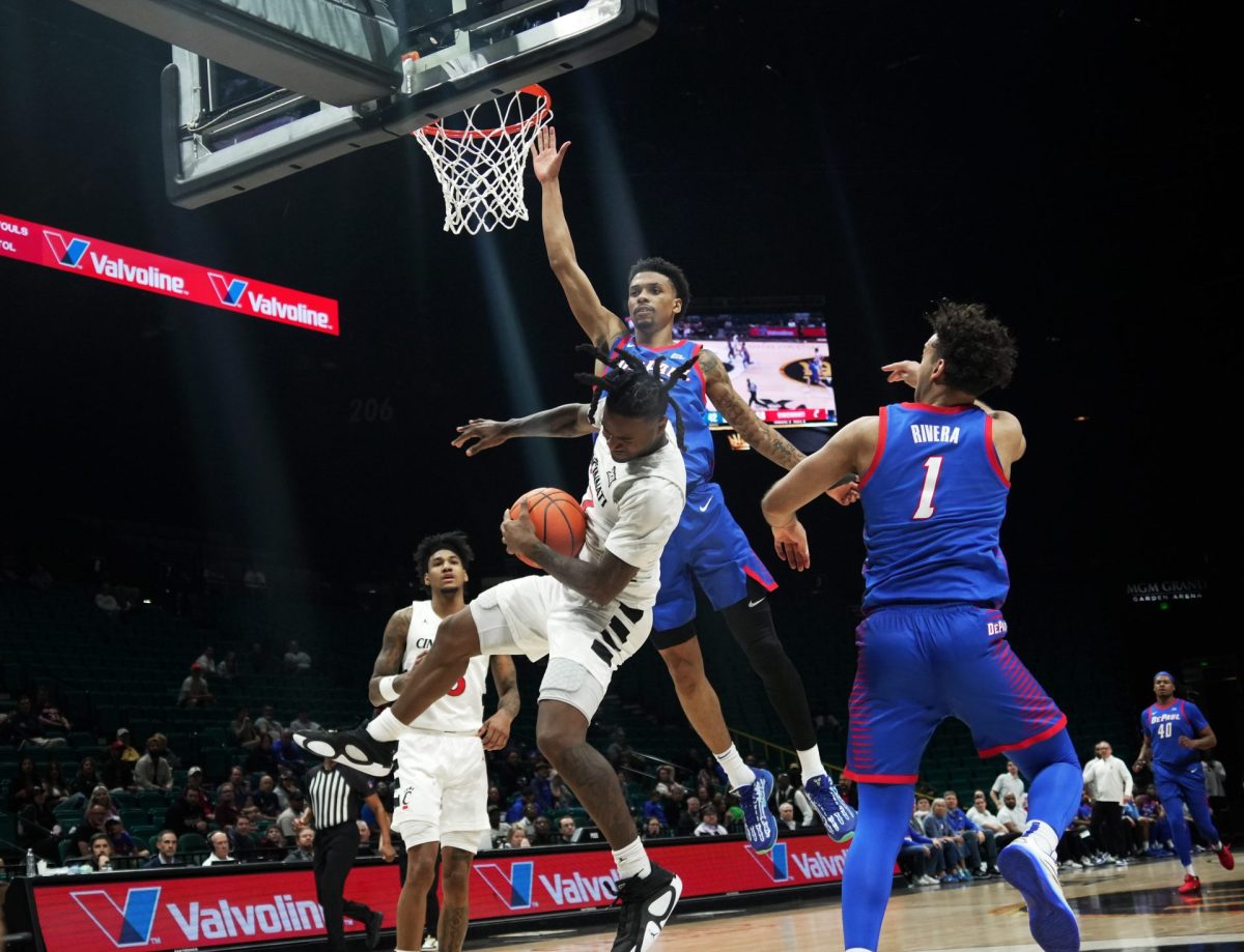 Cincinnati catches the ball while CJ Gunn and Isaiah Rivera jump to guard on Tuesday, April 1, 2025, at MGM Grand Garden Arena. Gunn led the way for the Blue Demons with 16 points. 