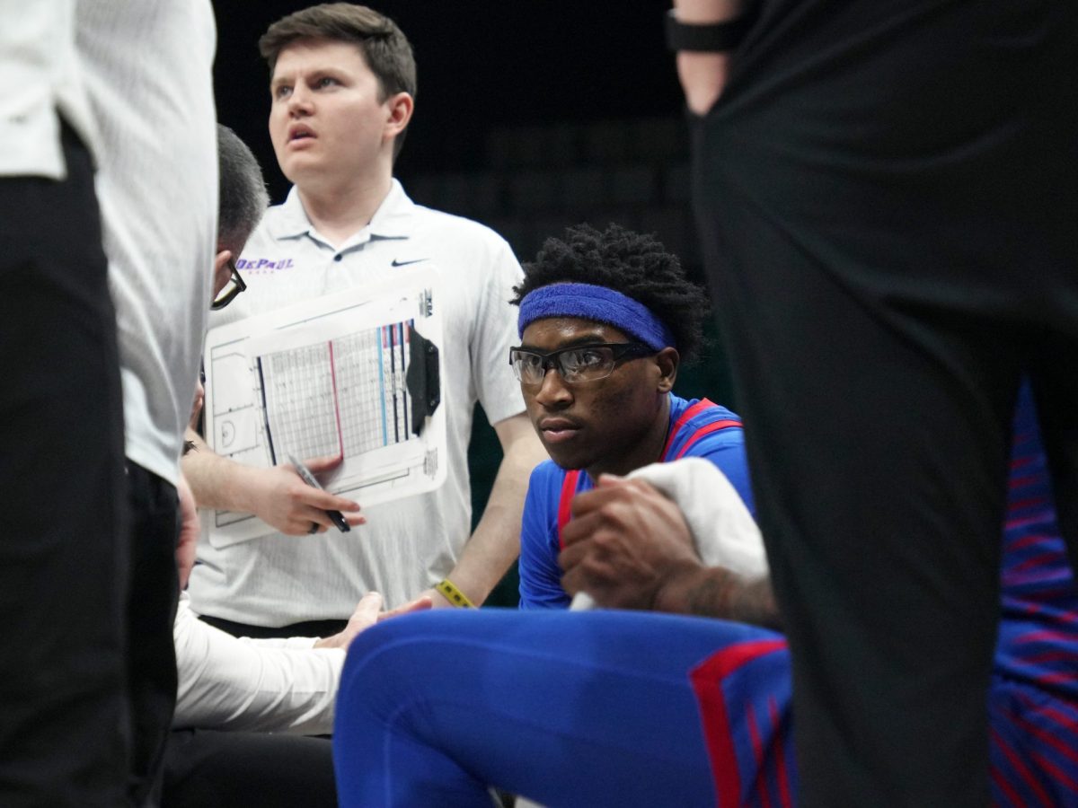 Layden Blocker listens to Chris Holtmann during a timeout in the second half on Tuesday, April 1, 2025, at MGM Grand Garden Arena. Blocker walked off the court with an arm injury but according to Holtmann, everything looks good.