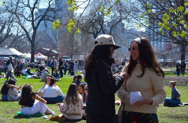 Olivia Potenziano and Anita Wary enjoy their fresh treats at Green City Market in Lincoln Park on Saturday, April 12, 2025. Many customers enjoy picnicking on the field of grass adjacent to the market.