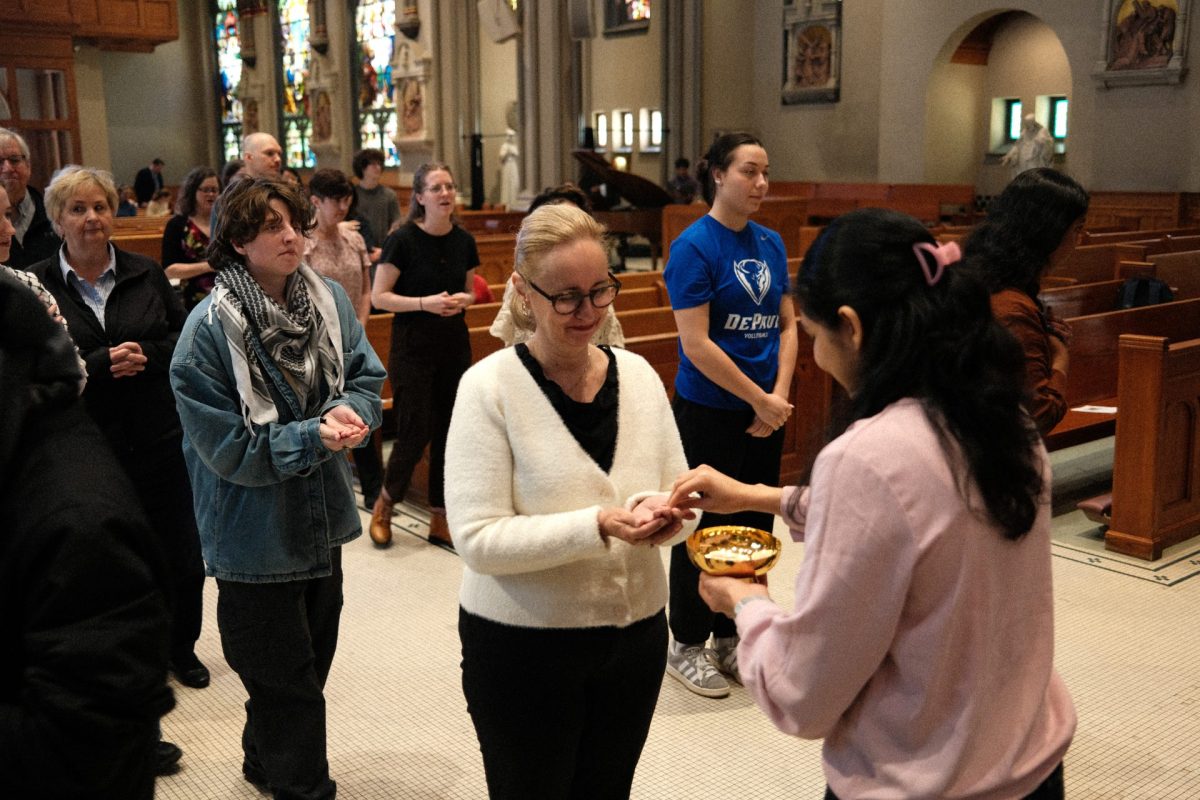 A line of people receive holy communion at St. Vincent DePaul Church during a memorial mass for Pope Francis Thursday, April 24. Francis' funeral will be held Saturday, April 26 in Rome.