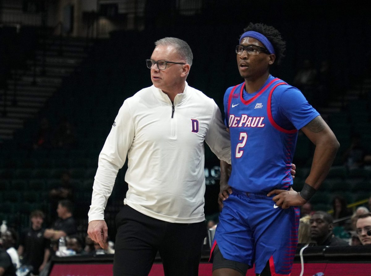 Chris Holtmann talks with Layden Blocker on the sidelines on Tuesday, April 1, 2025, during the first half at MGM Grand Garden Arena. Blocker announced that he will be playing with DePaul next season.