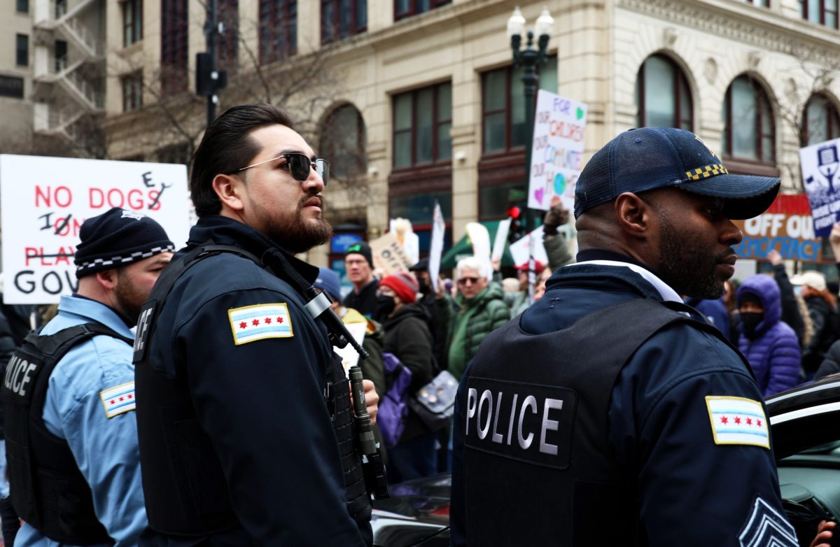 Police officers monitor the "Hands Off" protest in Chicago on Saturday, April 5, 2025. The protest was organized by the Chicago Federation of Labor Illinois Coalition for Immigrant and Refugee Rights, Equality Illinois, Sierra Club, Personal PAC and a some smaller organizations.