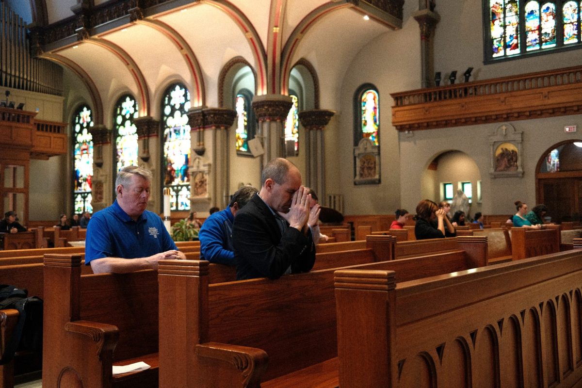 Churchgoers pray during Mass on Thursday, April 24, 2025, at St. Vincent de Paul Catholic Church. Pope John Paul II was the last pope to die while serving in office in 2005.