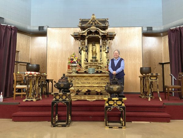Patti Nakai stands before the altar of the Uptown Buddhist Temple of Chicago, Tuesday, April 15, 2025. She has been a member of the temple since 1979 and is a Minister Emerita, meaning she his retired.