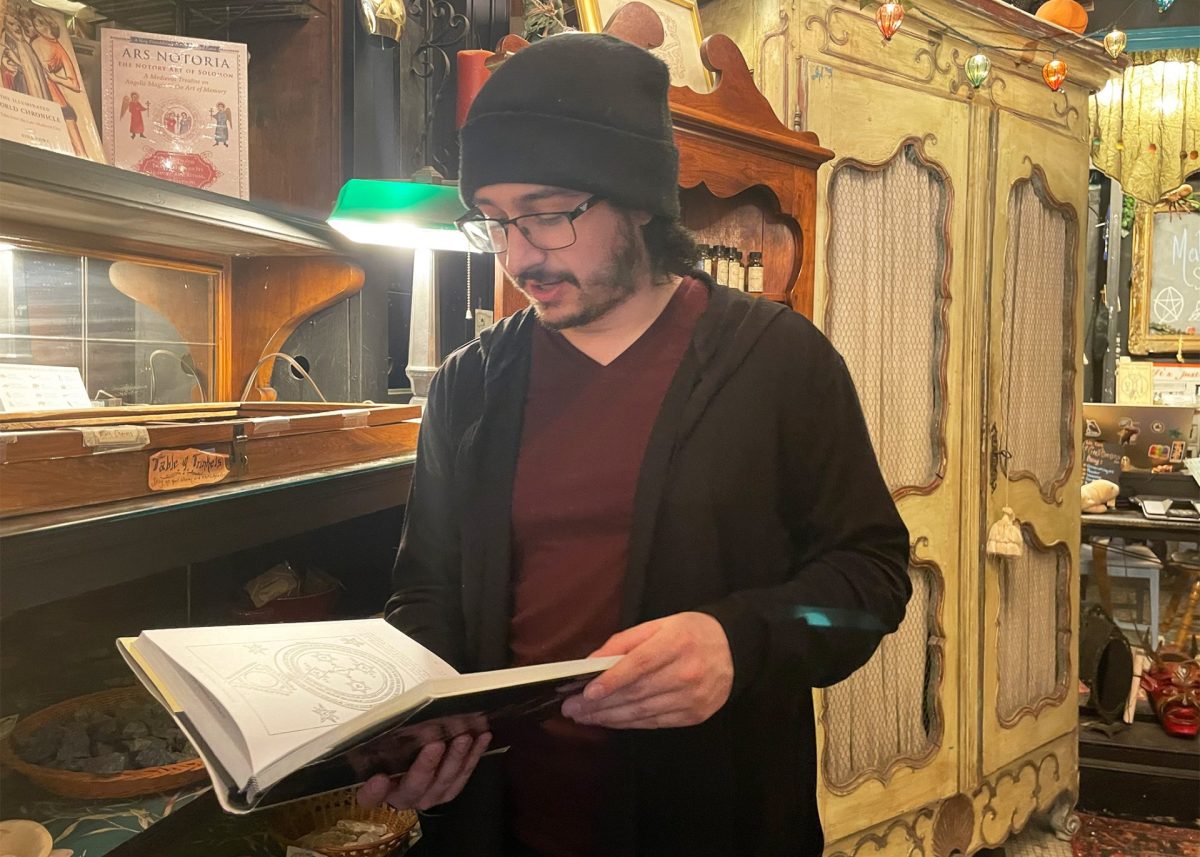 Lucas Lona holds “Techniques of Solomonic Magic” at the Malliway Bros. Shop in Rodgers Park on March 7, 2025. Lona says this is one of his favorite items in the store.

Photo by Alana Eve Schacher