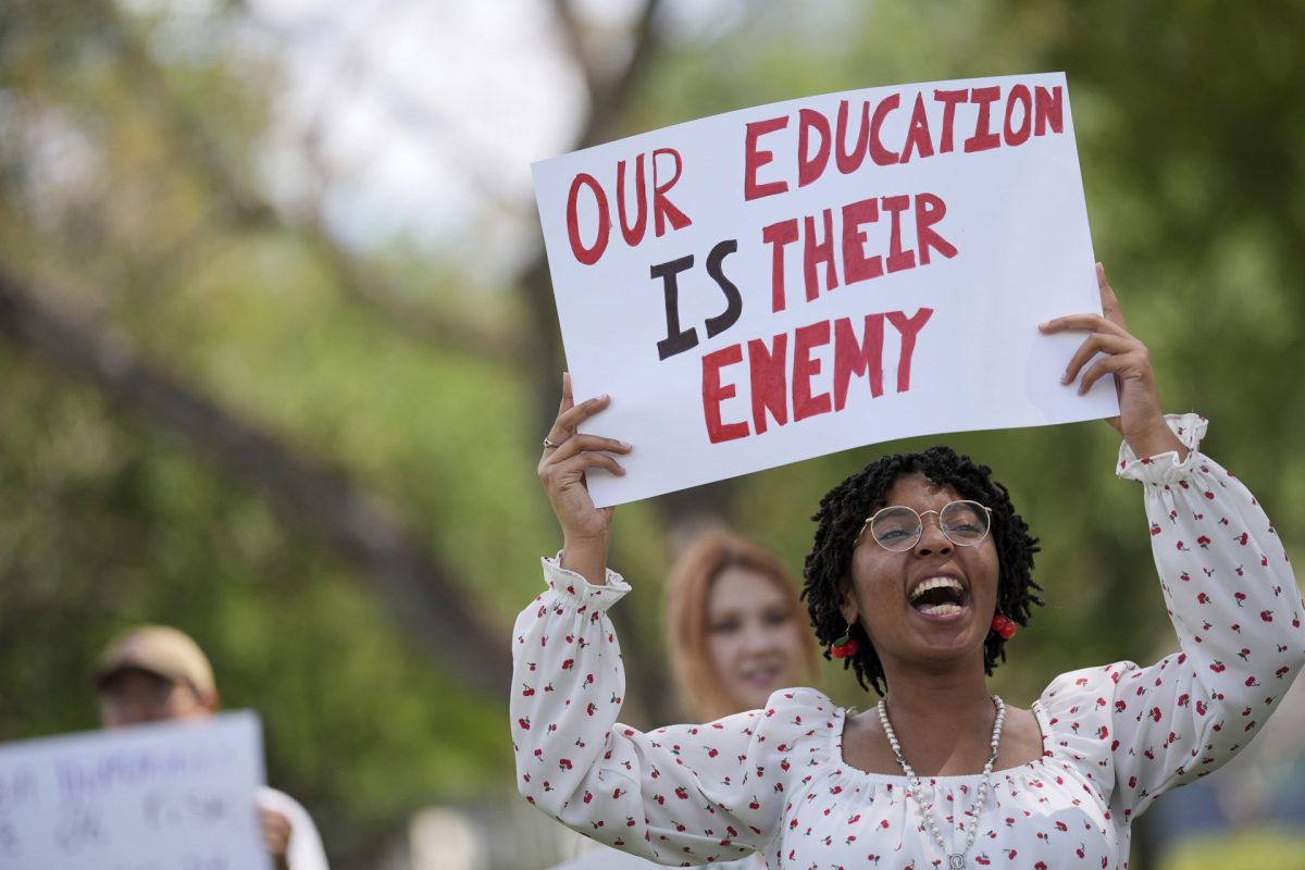 Cherish Lake, a Florida International University senior and hospitality major, participates in a protest against cuts in federal funding and an agreement by campus police to partner with Immigration and Customs Enforcement, on the FIU campus on a day of protests around the country in support of higher education, Thursday, April 17, 2025, in Miami. 