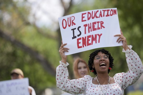 Cherish Lake, a Florida International University senior and hospitality major, participates in a protest against cuts in federal funding and an agreement by campus police to partner with Immigration and Customs Enforcement, on the FIU campus on a day of protests around the country in support of higher education, Thursday, April 17, 2025, in Miami. 