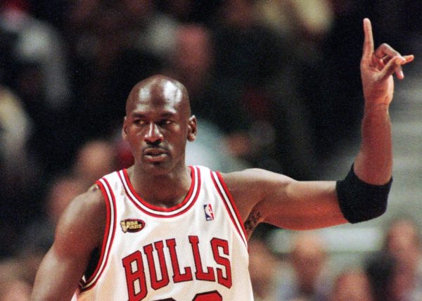 Chicago Bulls guard Michael Jordan signals to his teammates during the first quarter of Game 5 of the NBA finals in Chicago, Friday, June 12, 1998. 