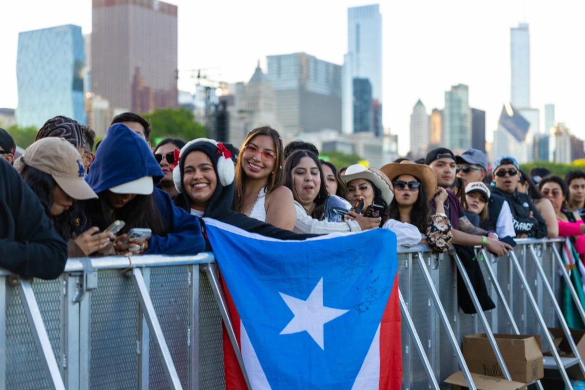 An festival goer raises the Puerto Rican flag at Sueños Festival on May 25, 2025, in Grant Park. Seven of the 22 artists performing on the main stage were Puerto Rican, representing nearly a third of the lineup.